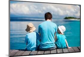 Back View of Father and Kids Sitting on Wooden Dock Looking to Ocean-BlueOrange Studio-Mounted Photographic Print