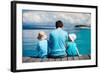 Back View of Father and Kids Sitting on Wooden Dock Looking to Ocean-BlueOrange Studio-Framed Photographic Print