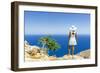 Back view of woman with fashion dress and hat looking at the sea from cliffs, Crete-Roberto Moiola-Framed Photographic Print