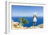Back view of woman with fashion dress and hat looking at the sea from cliffs, Crete-Roberto Moiola-Framed Photographic Print