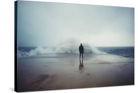 Back View Portrait of Young Man Standing against the Sea on a Large Concrete Pier with Big Wave Bea-GaudiLab-Stretched Canvas