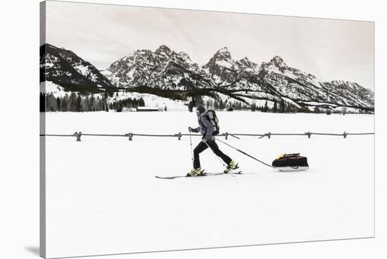 Backcountry skier under the Tetons, Grand Teton National Park, Wyoming, USA-Russ Bishop-Stretched Canvas