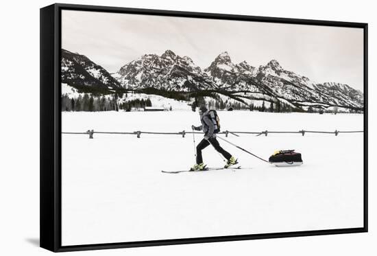 Backcountry skier under the Tetons, Grand Teton National Park, Wyoming, USA-Russ Bishop-Framed Stretched Canvas