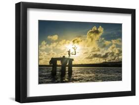 Backlit local boys jumping into the water of the lagoon of Wallis from a platform, Wallis and Futun-Michael Runkel-Framed Photographic Print
