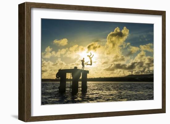 Backlit local boys jumping into the water of the lagoon of Wallis from a platform, Wallis and Futun-Michael Runkel-Framed Photographic Print