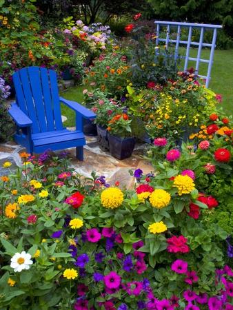 https://imgc.allpostersimages.com/img/posters/backyard-flower-garden-with-chair_u-L-PZL30S0.jpg?artPerspective=n