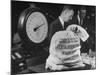 Bag of Checks Being Weighed on Scale at Bank-Herbert Gehr-Mounted Photographic Print