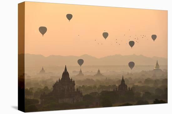 Bagan, balloons flying over ancient temples-Sarawut Intarob-Stretched Canvas