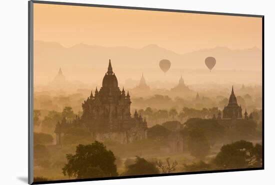 Bagan, Mandalay region, Myanmar (Burma). Pagodas and temples with balloons at sunrise.-Marco Bottigelli-Mounted Photographic Print