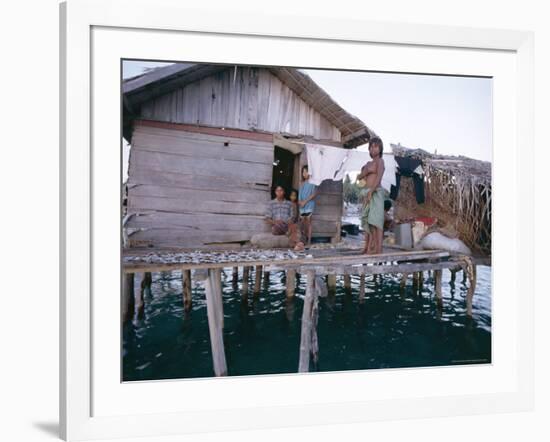 Bajau Family in Stilt House Over the Sea, with Fish Drying on Platform Outside, Sabah, Malaysia-Lousie Murray-Framed Photographic Print