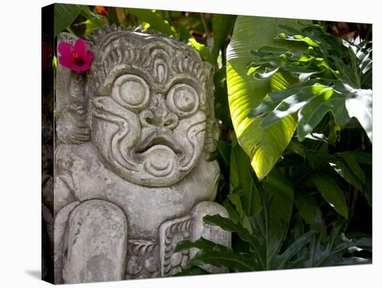 Bali, Ubud, a Stone Carving, Adorned with a Hibiscus Flower, Sits in Tropical Gardens-Niels Van Gijn-Stretched Canvas