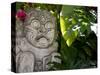 Bali, Ubud, a Stone Carving, Adorned with a Hibiscus Flower, Sits in Tropical Gardens-Niels Van Gijn-Stretched Canvas