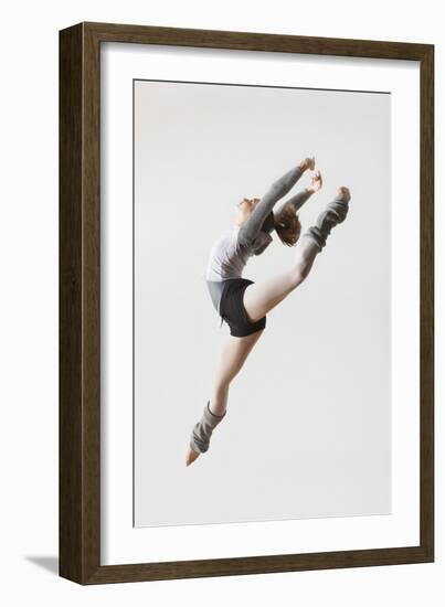 Ballerina Leaping in Mid-Air-null-Framed Photo