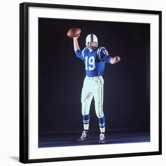 Baltimore Colts Football Player Johnny Unitas in Uniform While Holding Ball in Passing Stance-Yale Joel-Framed Premium Photographic Print