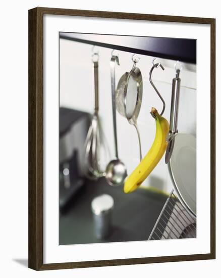 Banana and Kitchen Tools Hanging on Hooks in Kitchen-Kröger & Gross-Framed Photographic Print