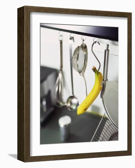 Banana and Kitchen Tools Hanging on Hooks in Kitchen-Kröger & Gross-Framed Photographic Print