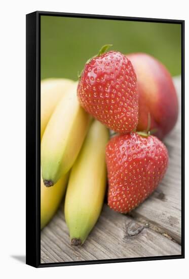 Bananas, Strawberries and Nectarine on Wooden Table-Foodcollection-Framed Stretched Canvas