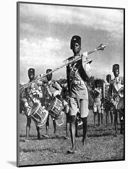 Bandsmen of the Northern Rhodesia Regiment Beat a Military Tattoo, Zimbabwe, Africa, 1936-null-Mounted Giclee Print
