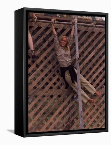 Barefoot Girl Swinging on Structure Containing Baby Chicks in Coop, Woodstock Music and Art Fair-John Dominis-Framed Stretched Canvas