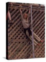 Barefoot Girl Swinging on Structure Containing Baby Chicks in Coop, Woodstock Music and Art Fair-John Dominis-Stretched Canvas