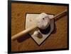 Baseball Bat with a Cap, and a Baseball on the Home Base-null-Framed Photographic Print