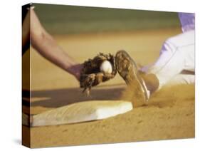 Baseball Player Sliding at a Base, and a Gloved Hand Holding a Ball-null-Stretched Canvas