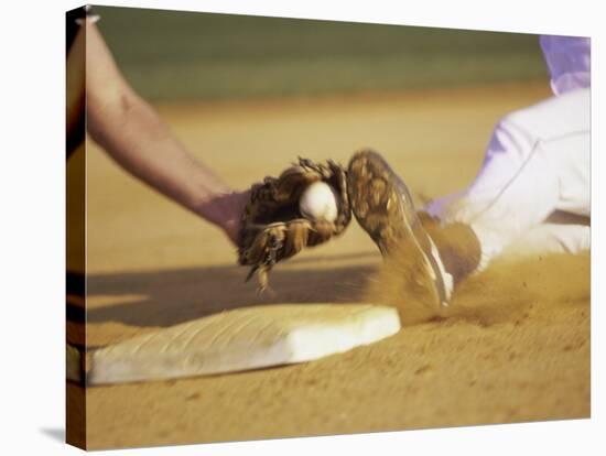 Baseball Player Sliding at a Base, and a Gloved Hand Holding a Ball-null-Stretched Canvas