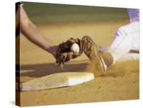 Baseball Player Sliding at a Base, and a Gloved Hand Holding a Ball-null-Stretched Canvas