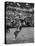 Basketball Player Tom Gola Leaping in the Air to Make a Shot During a Basketball Game-null-Stretched Canvas