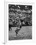 Basketball Player Tom Gola Leaping in the Air to Make a Shot During a Basketball Game-null-Framed Photographic Print