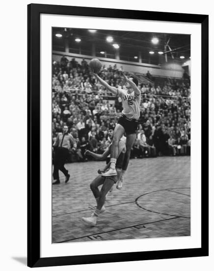 Basketball Player Tom Gola Leaping in the Air to Make a Shot During a Basketball Game-null-Framed Photographic Print