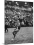 Basketball Player Tom Gola Leaping in the Air to Make a Shot During a Basketball Game-null-Mounted Photographic Print