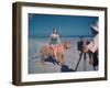 Bathing Beauty Sitting on Back of Large Tiger on Beach as Photographer Sets Up Camera-Eliot Elisofon-Framed Photographic Print