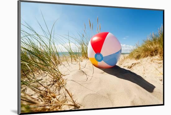 Beach Ball Resting in Sand Dune Concept for Childhood Summer Vacations, Family Holiday and Healthy-Flynt-Mounted Photographic Print