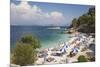 Beach Crowded with Holidaymakers, Kassiopi, Corfu, Ionian Islands, Greek Islands, Greece, Europe-Ruth Tomlinson-Mounted Photographic Print