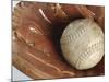 Beaten-Up Baseball in Baseball Glove-null-Mounted Photographic Print