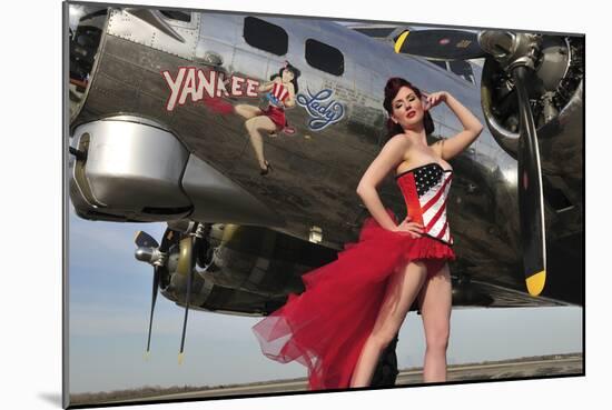 Beautiful 1940's Style Pin-Up Girl Standing under a B-17 Bomber-null-Mounted Photographic Print
