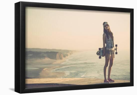Beautiful And Fashion Young Woman Posing With A Skateboard-iko-Framed Poster