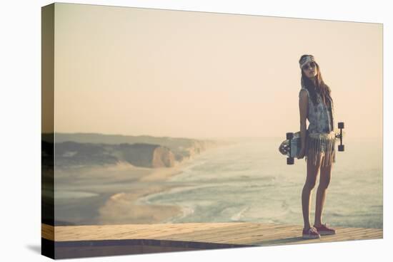 Beautiful And Fashion Young Woman Posing With A Skateboard-iko-Stretched Canvas