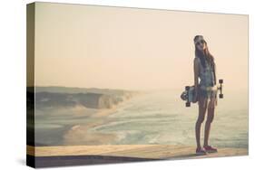 Beautiful And Fashion Young Woman Posing With A Skateboard-iko-Stretched Canvas