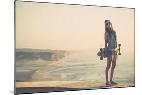 Beautiful And Fashion Young Woman Posing With A Skateboard-iko-Mounted Art Print