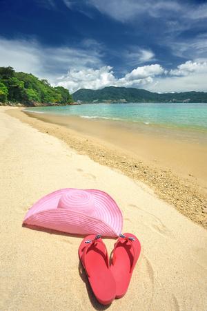 https://imgc.allpostersimages.com/img/posters/beautiful-beach-landscape-with-hat-and-flip-flops-in-thailand_u-L-Q105A8A0.jpg?artPerspective=n