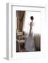 Beautiful Bride in White Wedding Dress Standing in Her Bedroom and Looking in Window-Malyugin-Framed Photographic Print