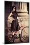 Beautiful Brunette Standing near Her Old Bicycle over City Background. Retro Style.-prometeus-Mounted Photographic Print