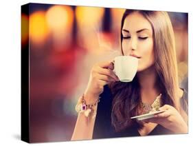 Beautiful Girl Drinking Tea or Coffee in Café-Subbotina Anna-Stretched Canvas