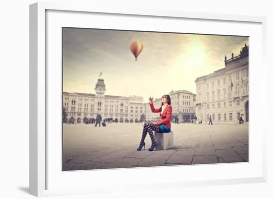 Beautiful Woman In Colored Clothes On A Square With Hot-Air Balloon In The Background-olly2-Framed Art Print