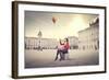 Beautiful Woman In Colored Clothes On A Square With Hot-Air Balloon In The Background-olly2-Framed Art Print