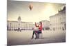 Beautiful Woman In Colored Clothes On A Square With Hot-Air Balloon In The Background-olly2-Mounted Art Print