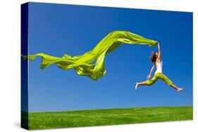 Beautiful Young Woman Jumping On A Green Meadow With A Colored Tissue-iko-Stretched Canvas