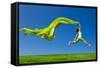 Beautiful Young Woman Jumping On A Green Meadow With A Colored Tissue-iko-Framed Stretched Canvas